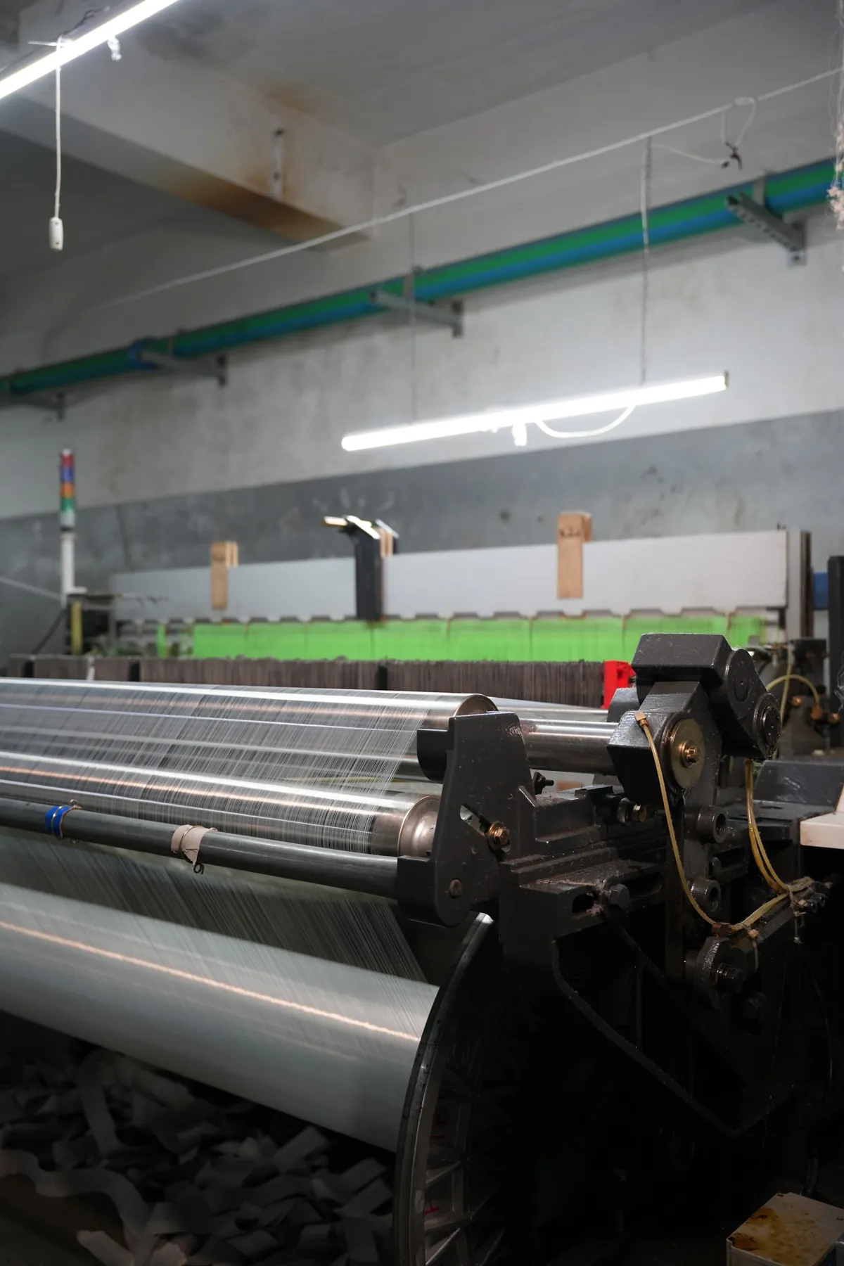 Loom with green warp sheet under tension